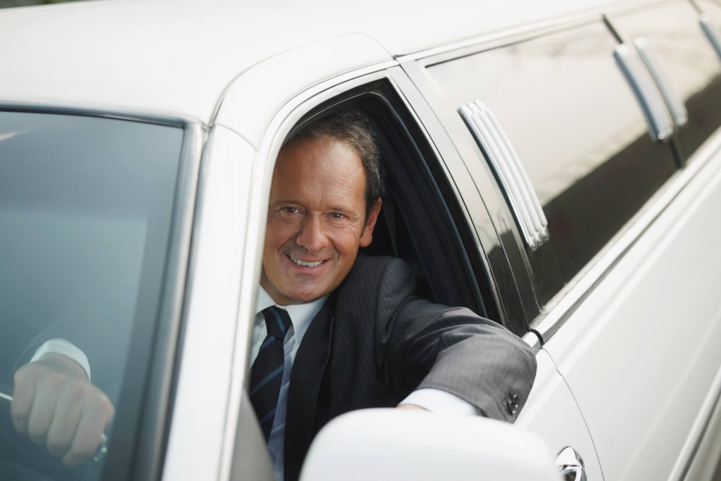Austin Homecoming Transportation man in limo Austin Homecoming transportation
