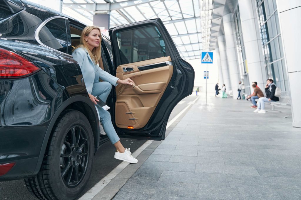 Austin Transportation Service woman stepping out of luxury car